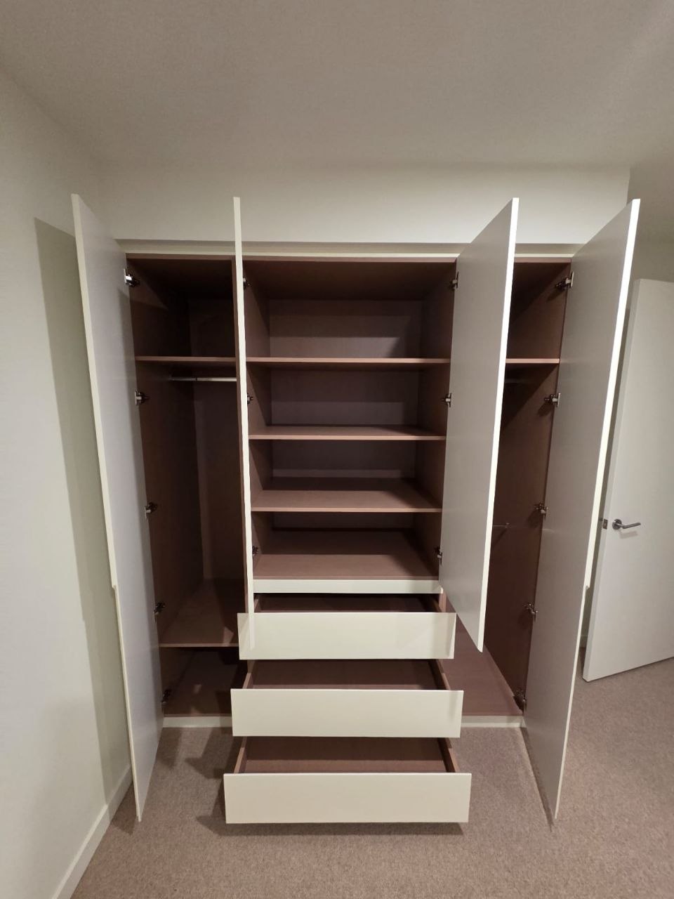 Built-in wardrobe with every door and drawer opened and cleaned during a Melbourne builders handover clean