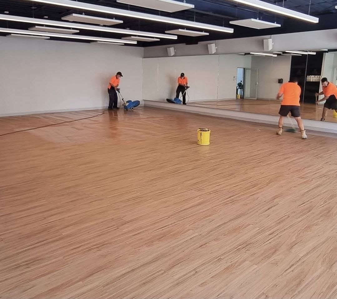 Blancoz cleaners scrubbing a studio floor during an out-of-hours commercial clean in Melbourne